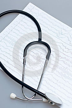 Ambulance, EEG graph and stethoscope on gray background