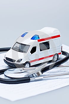 Ambulance, EEG graph and stethoscope on gray background