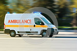 Ambulance on emergency call in motion blur with blue flashing light