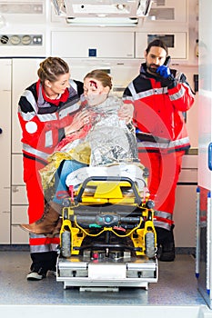 Ambulance helping injured woman