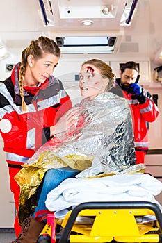 Ambulance helping injured woman