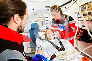 Ambulance helping injured woman with infusion