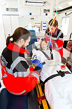 Ambulance helping injured woman with infusion