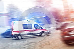 Ambulance racing through city traffic jam on slippery road with slush snow. Car accident on highway