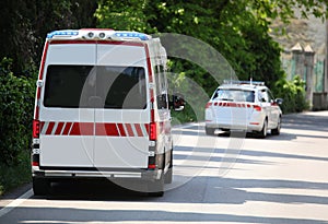 ambulance runs fast on the road preceded by the very fast medica