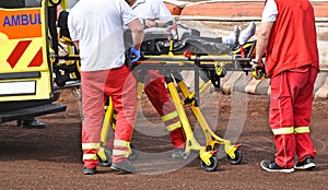 Ambulance stuff with a stretcher on the sport track