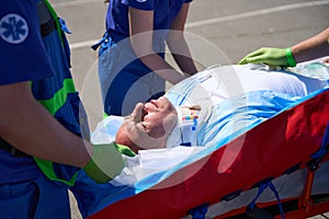 Ambulance team laid the patient for transportation on vacuum mattress