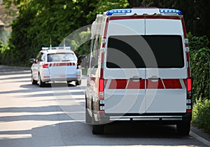 Ambulance van with flashing sirens running on the road and a med