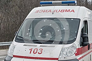 An ambulance was fired upon. The front of the car has multiple shrapnel damage. Emphasis on the windshield. concept of war