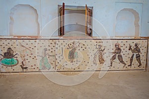 Amer, India - September 19, 2017: Detailled draws in the wall inside of the beautiful Amber Fort near Jaipur, Rajasthan