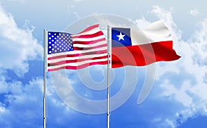 America and Chile flags together waving against blue sky