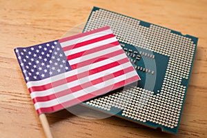 America flag on CPU computer (central processing unit) wooden background.
