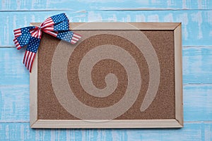 America ribbon on blue wood background.Wooden frame for text input