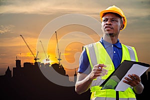 American African engineer or factory worker man working at construction site. Business, Building, Teamwork and People Concept.