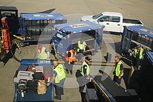 American Airlines baggage handlers uploading luggage at Miami International Airport