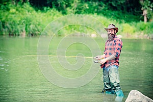 American angler fishing. Man fishing. Fly fishing in the pristine wilderness of Russia.