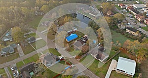 American apartment complex of residential condominimum quarter of aerial viewed in near small pond in Denham Springs