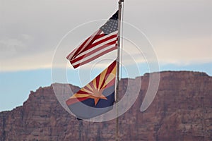 American and Arizona state flags together and a beautiful blurred rocky mountain in the background. photo