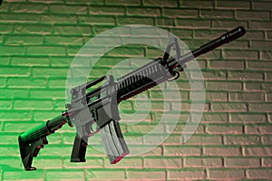 American army rifle M4A1 against a brick wall photo