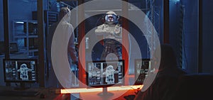 American astronaut testing spacesuit mobility