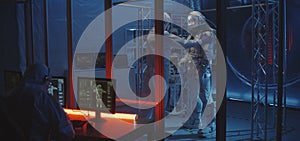 American astronaut testing spacesuit mobility