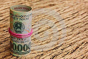 VIETNAM  bank note on vintage brown wood background. DONG money circulated world wild. money for payment,seaving, legal