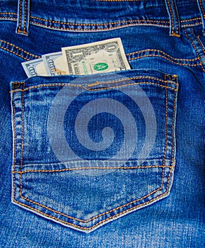 American banknotes in jeans pocket. A note in denominations of $ 100 peeps, stick out from the back, the foremost pants pocket.