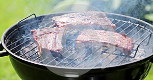 American barbecue - preparing pork ribs on charcoal grill