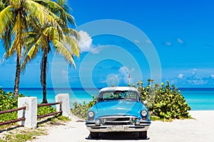 American blue 1955 classic car with a white roof parked direct on the beach in Varadero Cuba