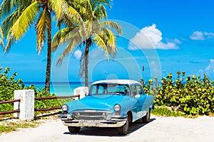 American blue 1955 classic car with a white roof parked direct on the beach in Varadero Cuba