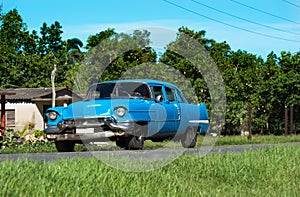 American blue Chevrolet classic car on the country road in Santa Clara - Serie Cuba Reportage