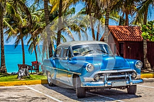 American blue Chevrolet classic car with silver roof parked on the beach in Varadero Cuba - Serie Cuba Reportage