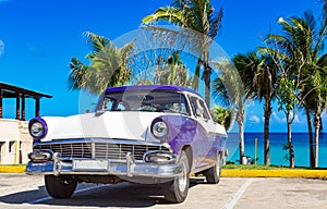 American blue white 1956 vintage car parked direct on the beach in Havana Cuba - Serie Cuba