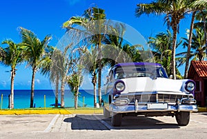 American blue white 1956 vintage car parked direct on the beach in Havana Cuba - Serie Cuba