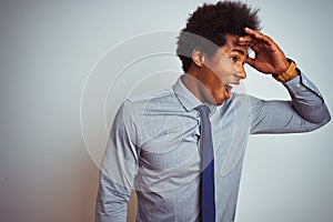 American business man with afro hair wearing shirt and tie over isolated white background very happy and smiling looking far away