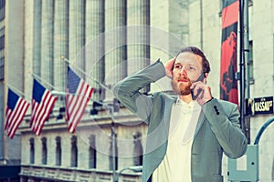 Young man traveling in New York City, talking on cell phone