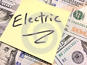American cash money and yellow paper note with text Electric photo
