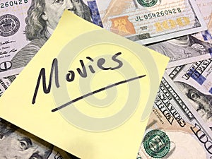 American cash money and yellow post it note with text Movies photo