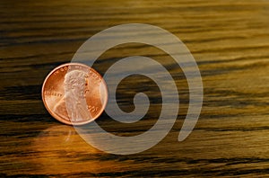 Cent copper coin on wooden background