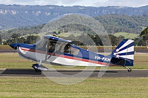 American Champion 8KCAB single engine light aircraft VH-FKM at Illawarra Regional Airport.