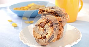 american chocolate chip cookie closeup. breakfast on a sunny morning. pastries on a blue table. sweets on a plate