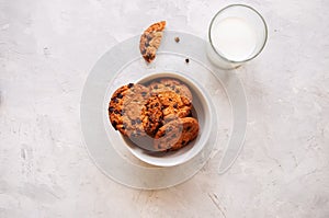 American chocolate chip cookies with glass of milk on a white st