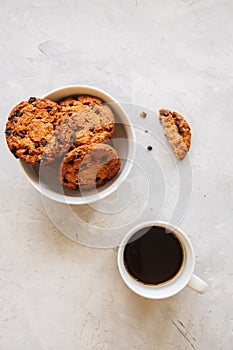 American chocolate chip cookies in a white bowl cup of coffee on