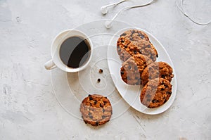 American chocolate chip cookies in a white plate cup of coffee