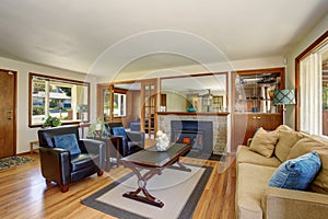 American classic Living room interior with black leather armchairs and fireplace.