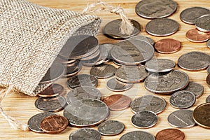 American Coins spilling out of a Burlap Bag