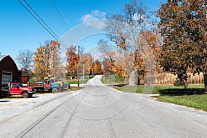 American country road with old farm equipment on a sunny fall day