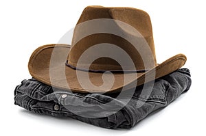 American cowboy wear, western design and country fashion conceptual idea with folded pair of black denim jeans and brown cowboy