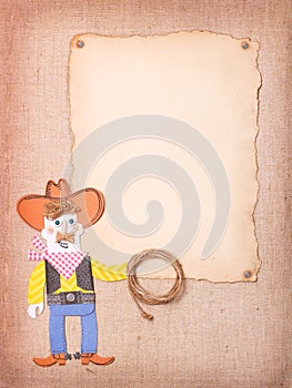 American Cowboy in wild west hat and boots with lasso on old pap