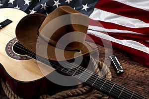 American culture, living on a ranch and country muisc concept theme with a cowboy hat, USA flag, acoustic guitar, harmonica and a